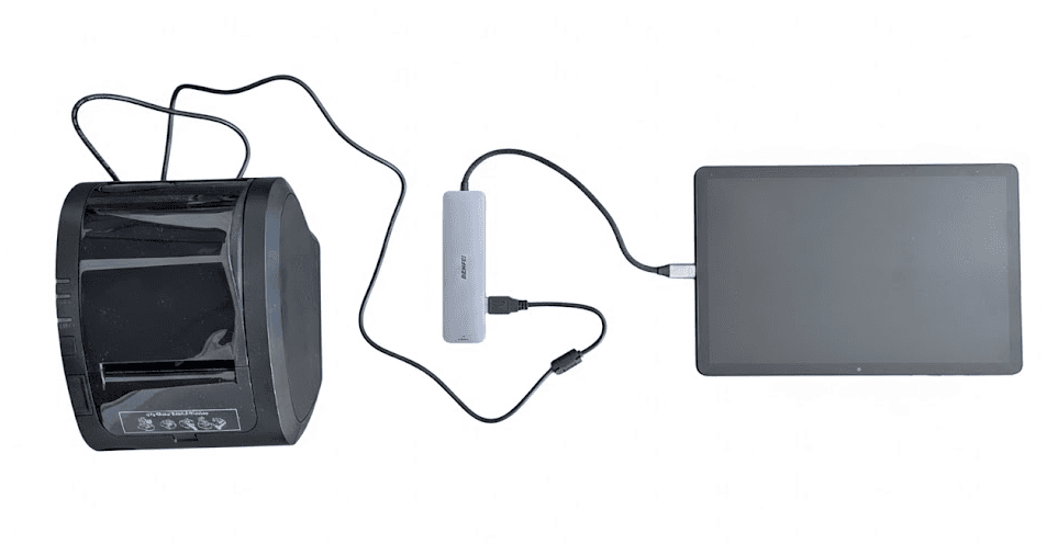 The same parts connected: the printer's cable runs into the hub, and the hub's cable into the tablet